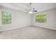 Spacious main bedroom with tray ceiling, large windows, and plush carpeting at 21 Misty Hollow Ct, Euharlee, GA 30145