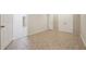 Basement room featuring tiled flooring, neutral paint and trim, and access to two different doorways at 225 Bayswater Dr, Suwanee, GA 30024