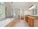 Bathroom featuring soaking tub, glass shower, and double vanity at 225 Bayswater Dr, Suwanee, GA 30024
