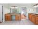 Spacious bathroom with double vanities, granite countertops, tile floor, and an open doorway to a bedroom at 225 Bayswater Dr, Suwanee, GA 30024