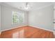 Bedroom with a ceiling fan, hardwood floors, window view and neutral-colored walls and trim at 225 Bayswater Dr, Suwanee, GA 30024
