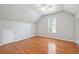 Bedroom features a ceiling fan, hardwood floors, storage closet and natural light from the window at 225 Bayswater Dr, Suwanee, GA 30024