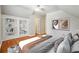 Comfortable bedroom features a built-in bookshelf and hardwood flooring at 225 Bayswater Dr, Suwanee, GA 30024