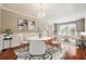Bright dining room features hardwood floors and elegant chandelier at 225 Bayswater Dr, Suwanee, GA 30024