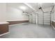 Clean garage with epoxy flooring and two car capacity, ready for parking and storage at 225 Bayswater Dr, Suwanee, GA 30024