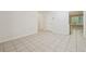 Hallway with tile floors, neutral paint, and access to a room with a window and another with an island at 225 Bayswater Dr, Suwanee, GA 30024