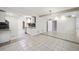 Spacious living room featuring tile floors, modern lighting, and an open floor plan at 225 Bayswater Dr, Suwanee, GA 30024