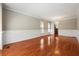 Open-concept living room with hardwood floors, wainscoting, chandelier, and natural light at 225 Bayswater Dr, Suwanee, GA 30024