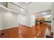 Large living area with soaring ceilings open to the kitchen area with hardwood floors throughout at 225 Bayswater Dr, Suwanee, GA 30024
