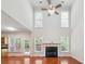 Living room features a fireplace, tall ceilings, ample natural light, and access to the backyard at 225 Bayswater Dr, Suwanee, GA 30024