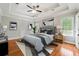Relaxing main bedroom with tray ceiling, hardwood floors, and natural light at 225 Bayswater Dr, Suwanee, GA 30024