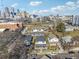 Aerial view of homes in a city neighborhood with clear skies and a vibrant cityscape in the background at 230 Woodward Se Ave, Atlanta, GA 30312