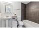 A modern bathroom with tiled walls, pedestal sink, and contemporary fixtures at 230 Woodward Se Ave, Atlanta, GA 30312