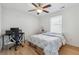 A cozy bedroom with a ceiling fan, computer desk, and bright window offering natural light at 230 Woodward Se Ave, Atlanta, GA 30312