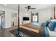 Comfortable bedroom featuring a ceiling fan, hardwood floors, a TV, and a bed with decorative pillows and blanket at 230 Woodward Se Ave, Atlanta, GA 30312