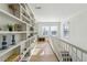 Bright hallway with built-in shelving, light hardwood floors, and natural light from windows at 230 Woodward Se Ave, Atlanta, GA 30312