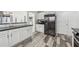 Modern kitchen with stainless steel appliances, ample cabinet space, granite countertops, and stylish hardwood floors at 230 Woodward Se Ave, Atlanta, GA 30312