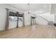 Expansive living room with sleek wood floors, large windows with curtains, a modern chandelier and staircase access at 230 Woodward Se Ave, Atlanta, GA 30312