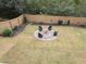 Spacious backyard with a fire pit, modern chairs, and landscaped yard at 3770 Falling Leaf Ln, Cumming, GA 30041