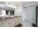 Bathroom with double sinks, marble tile, modern lighting, and large mirror at 3770 Falling Leaf Ln, Cumming, GA 30041