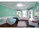Bright bedroom boasts natural light, white desk, and a comfortable bed, perfect for work or relaxation at 3770 Falling Leaf Ln, Cumming, GA 30041