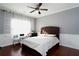 Bedroom with hardwood floors, ceiling fan, and tufted headboard at 3770 Falling Leaf Ln, Cumming, GA 30041