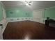 Green bedroom featuring hardwood floors, paneled walls, and a ceiling fan for a bright and inviting atmosphere at 3770 Falling Leaf Ln, Cumming, GA 30041