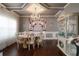 Elegant dining room with hardwood floors, chandelier, and decorative display cabinet at 3770 Falling Leaf Ln, Cumming, GA 30041