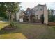 Two-story home with brick and siding exterior, well-manicured lawn, two-car garage, and tasteful landscaping at 3770 Falling Leaf Ln, Cumming, GA 30041