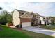 Two-story home with brick and siding exterior, manicured lawn, two-car garage, and attractive landscaping at 3770 Falling Leaf Ln, Cumming, GA 30041
