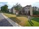 Two-story home with brick and siding exterior, manicured lawn, two-car garage, and landscaped yard at 3770 Falling Leaf Ln, Cumming, GA 30041