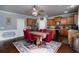 Eat-in kitchen features wood cabinets, granite countertops, stainless steel appliances, and a dining table at 3770 Falling Leaf Ln, Cumming, GA 30041