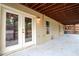 Covered patio with double doors, wooden ceiling, and outdoor living space perfect for relaxation at 3770 Falling Leaf Ln, Cumming, GA 30041