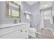 Bathroom features white vanity with marble countertop, modern fixtures, and neutral paint at 582 Linda Ln, Powder Springs, GA 30127