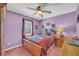 Cozy bedroom featuring a comfortable bed, ceiling fan, and a bright window at 582 Linda Ln, Powder Springs, GA 30127