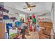 Bedroom or storage space filled with boxes and shelves, featuring light wood floors and ceiling fan at 582 Linda Ln, Powder Springs, GA 30127