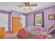 Bedroom showcasing a cozy bed, natural light and a ceiling fan at 582 Linda Ln, Powder Springs, GA 30127