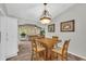 Well-lit dining area with hardwood floors, a wooden table, and an ornate chandelier, perfect for everyday dining at 582 Linda Ln, Powder Springs, GA 30127