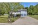 Charming two-story home with a well-maintained front yard and a two-car garage on a sunny day at 582 Linda Ln, Powder Springs, GA 30127