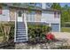 Charming home entrance featuring a stone facade, cozy balcony, and staircase leading to the front door at 582 Linda Ln, Powder Springs, GA 30127
