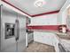 Spacious kitchen featuring stainless steel refrigerator and modern appliances for a convenient cooking experience at 582 Linda Ln, Powder Springs, GA 30127