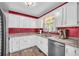 Bright kitchen with white cabinets, stainless steel appliances, and stylish countertops, perfect for cooking and entertaining at 582 Linda Ln, Powder Springs, GA 30127