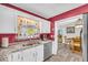 Efficient kitchen with white cabinets, stainless steel appliances, and stylish backsplash, perfect for cooking and serving at 582 Linda Ln, Powder Springs, GA 30127