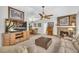 Comfortable living room featuring a stone fireplace, plush seating, and a ceiling fan for added comfort at 582 Linda Ln, Powder Springs, GA 30127