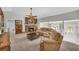 Inviting living room featuring a stone fireplace, neutral walls, plush seating, and natural light at 582 Linda Ln, Powder Springs, GA 30127