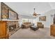 Cozy living room with a stone fireplace, plush seating, and a ceiling fan for added comfort at 582 Linda Ln, Powder Springs, GA 30127