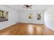 Bright bedroom featuring hardwood floors, a ceiling fan, and multiple windows that provide ample natural light at 964 Crane Ne Rd, Atlanta, GA 30324