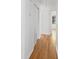 Bright hallway featuring hardwood floors, fresh white walls, and closet storage at 964 Crane Ne Rd, Atlanta, GA 30324