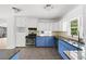 Modern kitchen featuring blue lower cabinets, stainless steel appliances, and ample counter space at 964 Crane Ne Rd, Atlanta, GA 30324