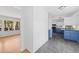 Bright kitchen with blue cabinets, tiled floor, and modern appliances adjacent to a light-filled dining area at 964 Crane Ne Rd, Atlanta, GA 30324